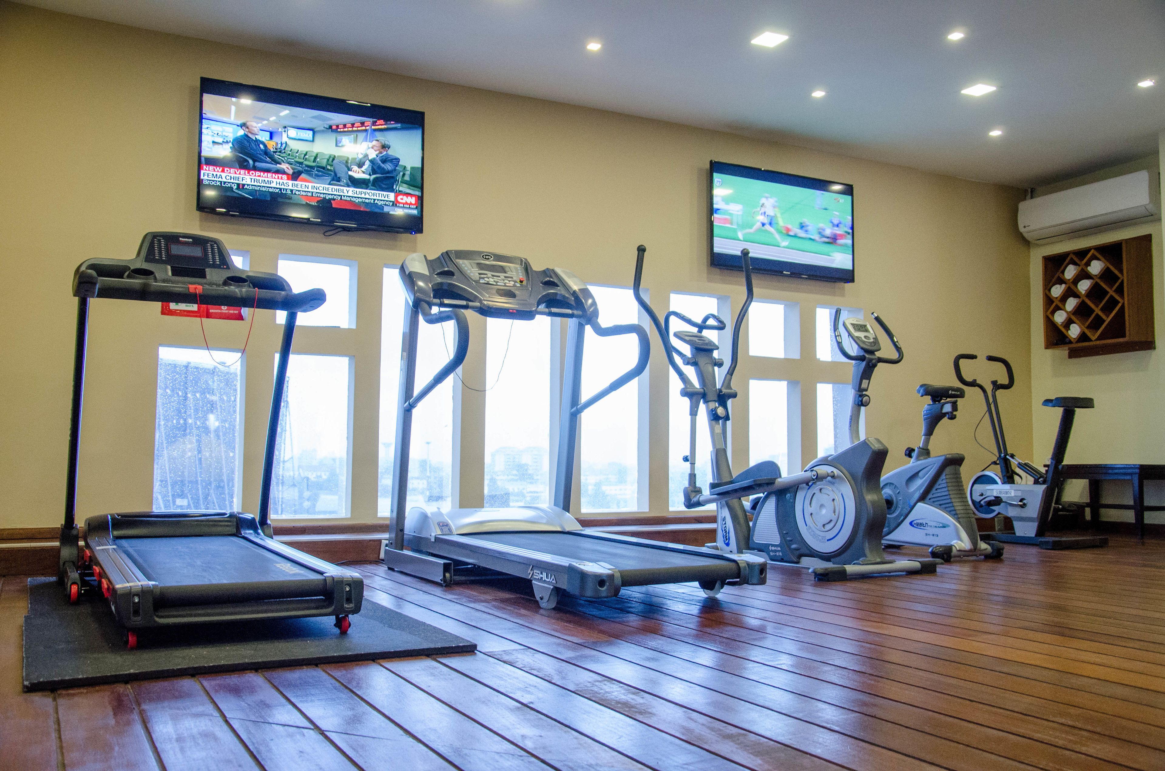 A gym with treadmills, ellipticals, and stationary bikes.