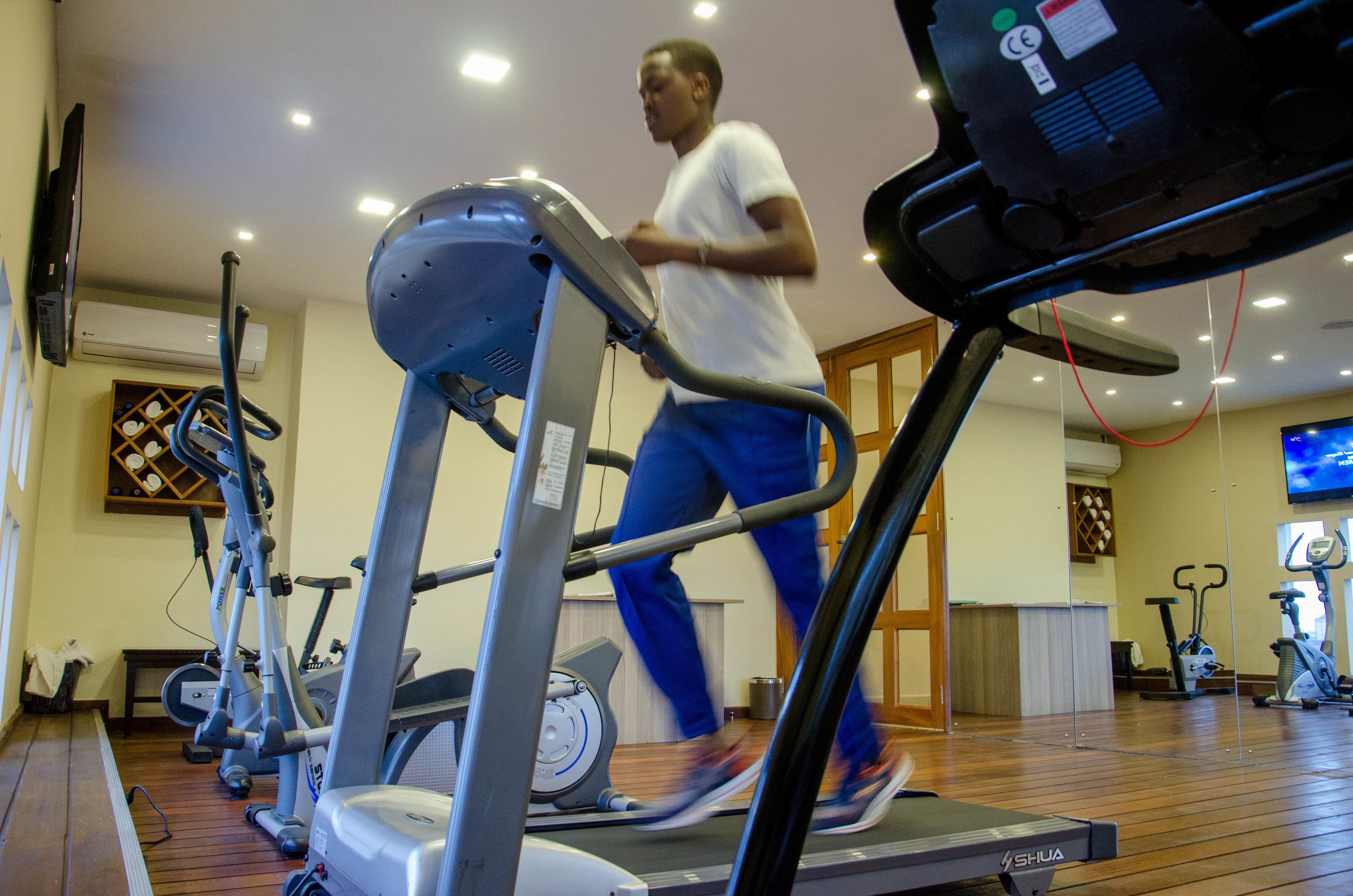 A gym with treadmills, stationary bikes, and an elliptical machine.