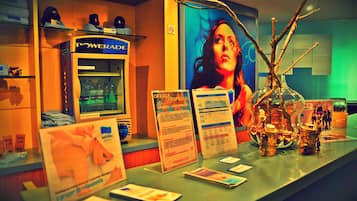 A counter with a Powerade refrigerator, promotional materials, and a decorative vase.