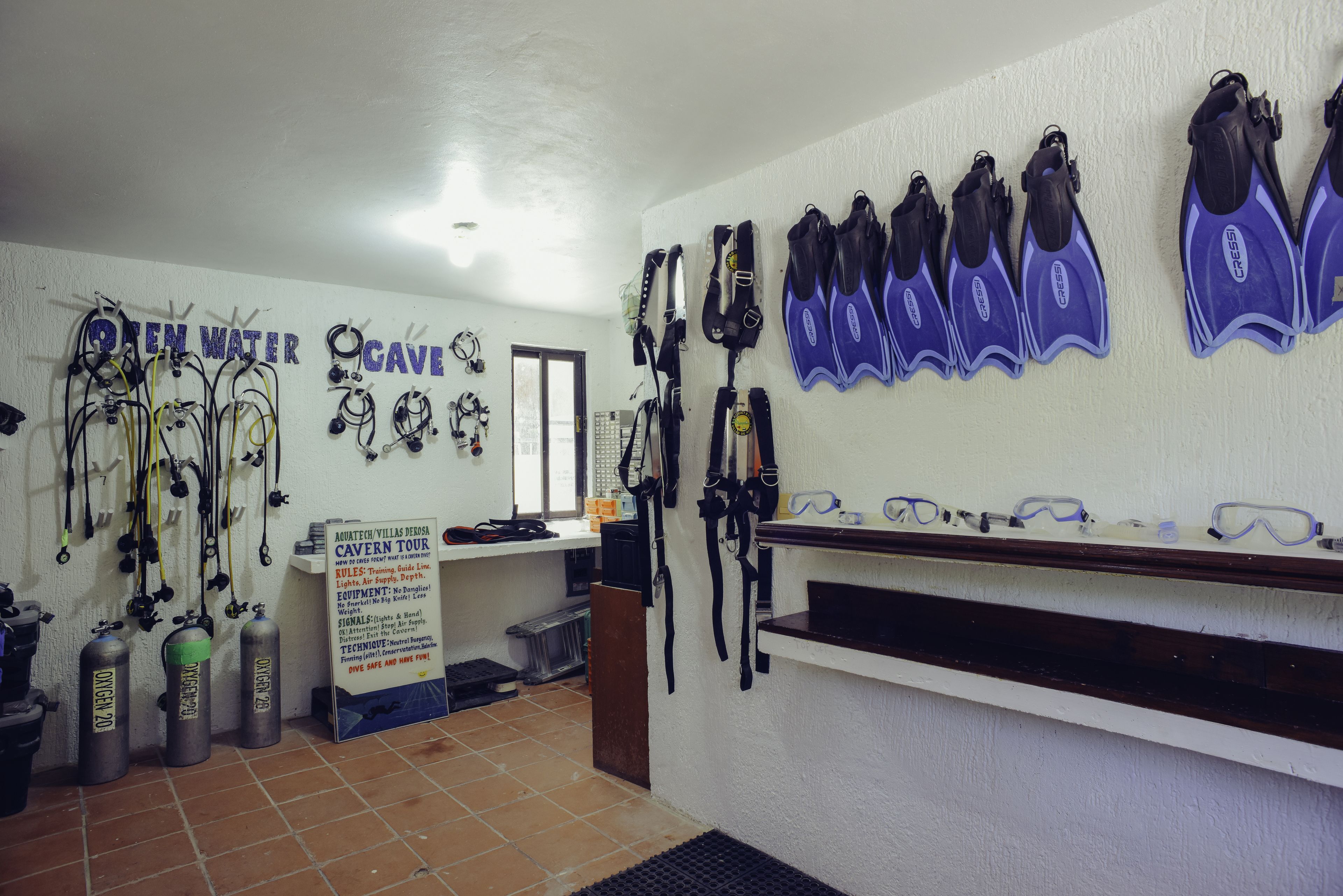 A dive shop with various diving equipment, including fins, masks, and oxygen tanks.