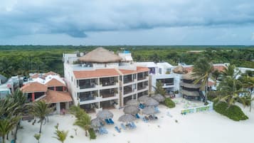 På stranden, hvit sand, solsenger og parasoller