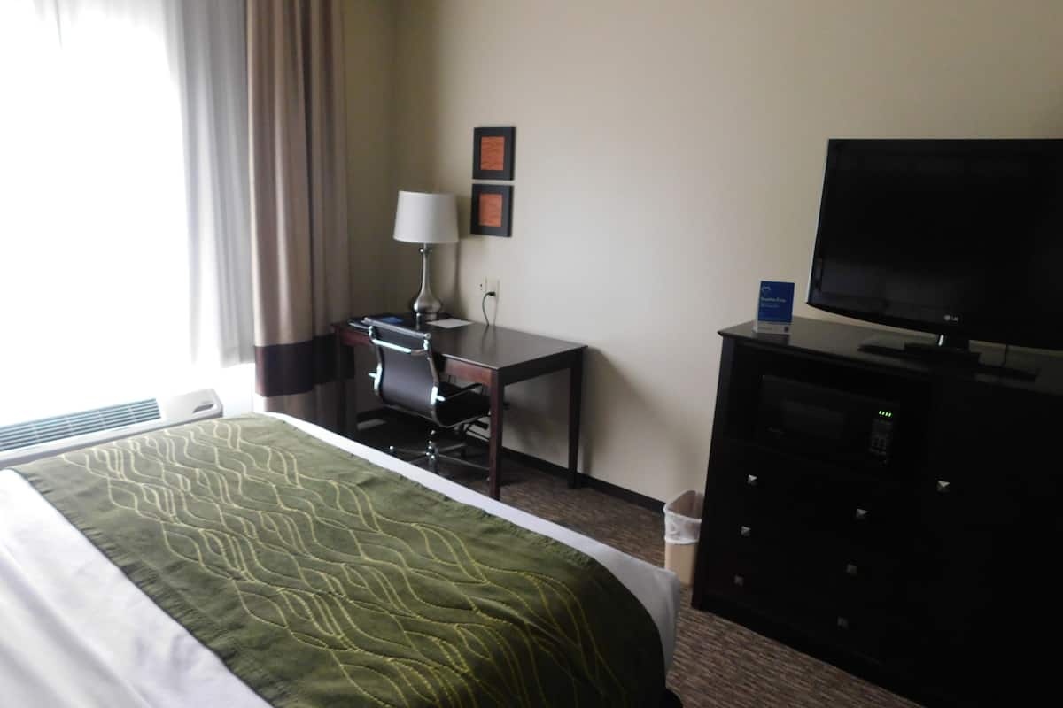 Desk, laptop workspace, blackout drapes, iron/ironing board
