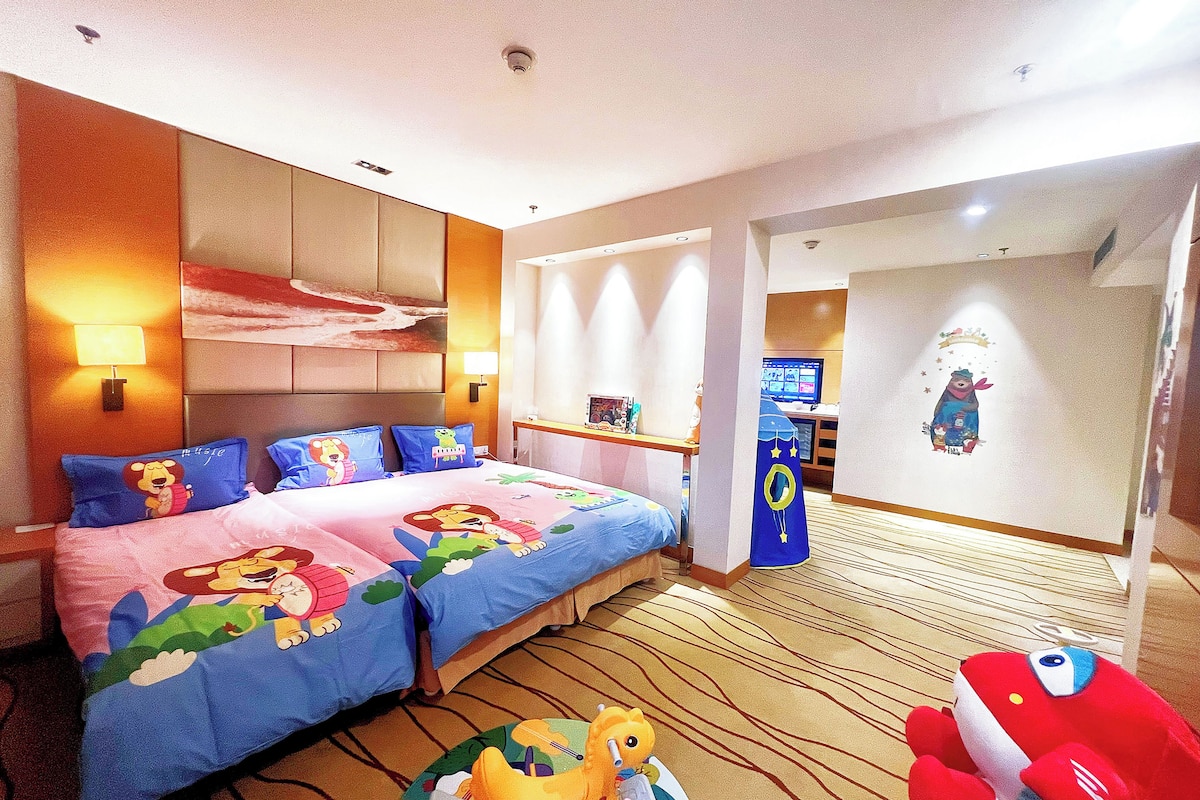 A hotel room with a large bed, two pillows, a nightstand, a TV, and a wall decoration.