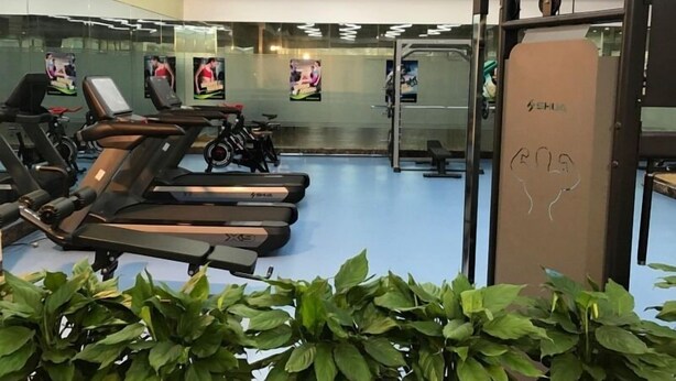 A gym with treadmills, stationary bikes, and weightlifting equipment. - GreenTree Inn Hefei XiYou Road Hotel (Hefei)