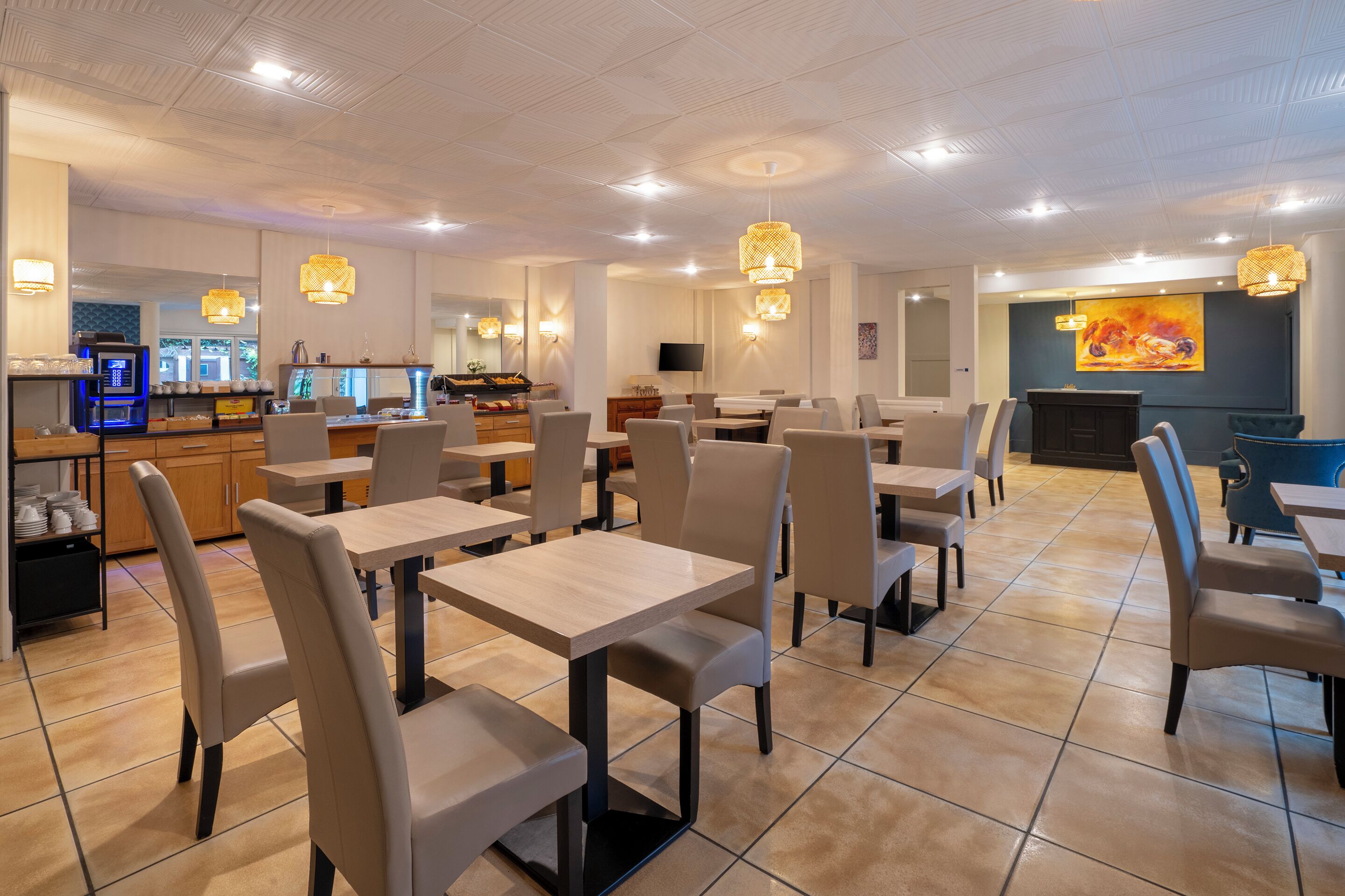 A modern restaurant with multiple dining tables and chairs, a bar area, and a television screen.