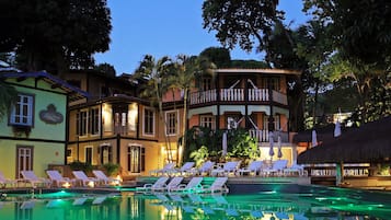 Relax by the pool surrounded by lush greenery and enjoy the tranquil atmosphere.