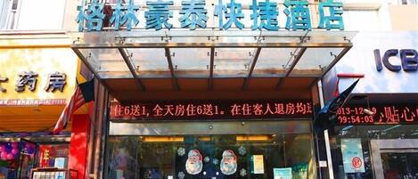 A hotel with a clear signboard, a visible entrance, and a glass facade.
