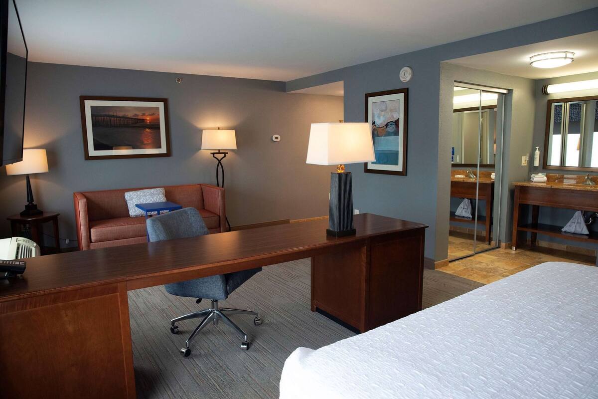 Desk, laptop workspace, blackout drapes, iron/ironing board