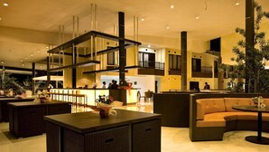 A spacious lobby with a central island, seating areas, and a reception desk. - Palace Hotel (Cipanas)