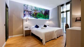 A modern hotel room with a large bed, two bedside tables, a desk, and a large window with curtains.