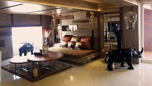 A modern living room with a sofa, coffee table, and decorative items.