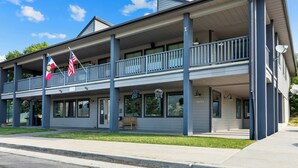 A two-story building with a balcony, flags, and a number '3618' on the side. - WorldMark Wolf Creek (Eden)