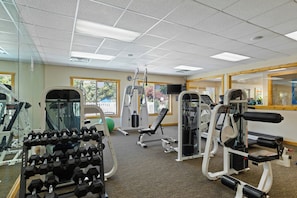 A gym with various exercise equipment, including dumbbells, a treadmill, and weight machines. - WorldMark Wolf Creek (Eden)