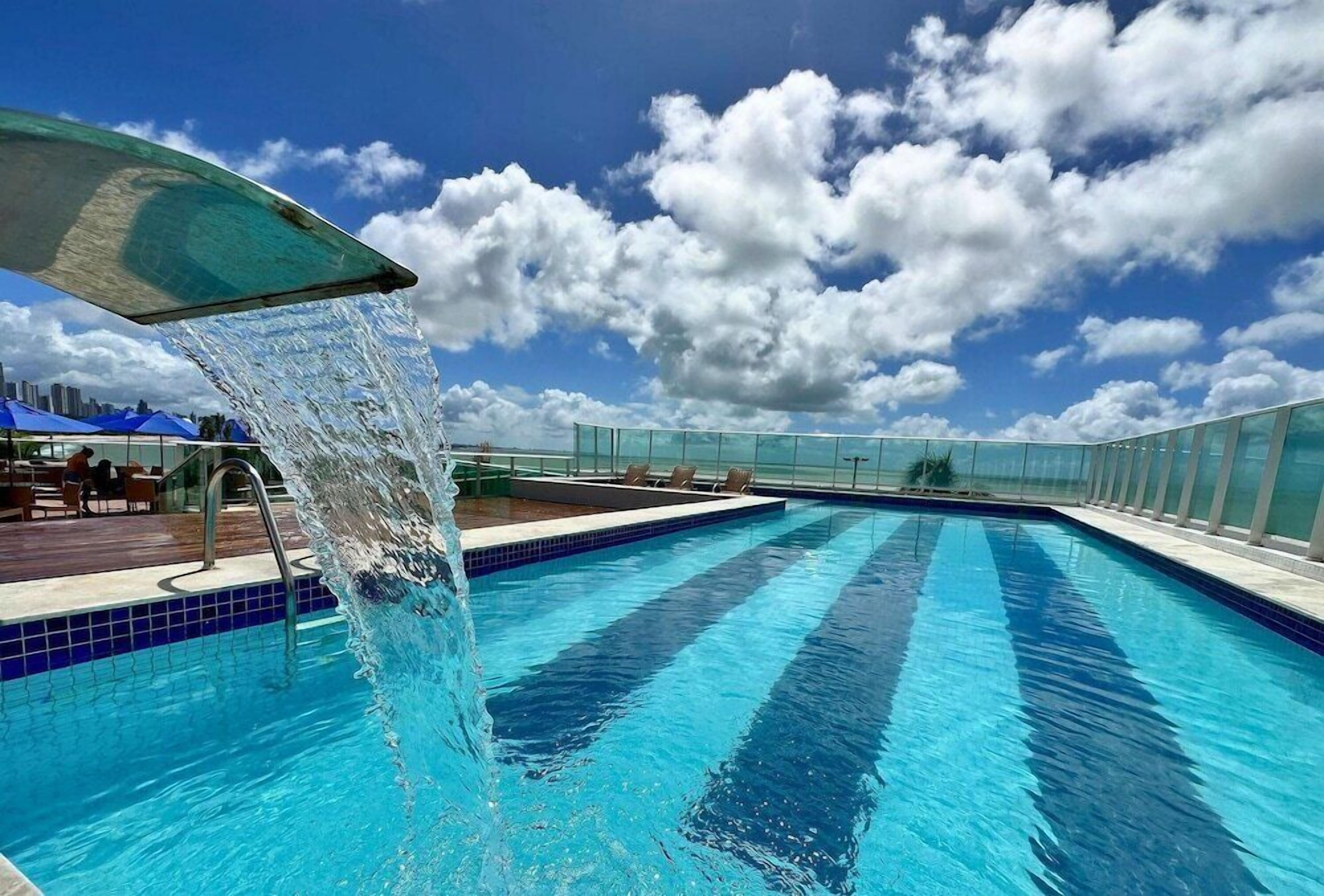 Piscina externa, guarda-sóis, espreguiçadeiras