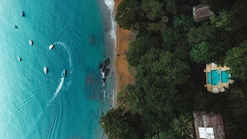 Outdoor pool, an infinity pool, pool umbrellas, pool loungers