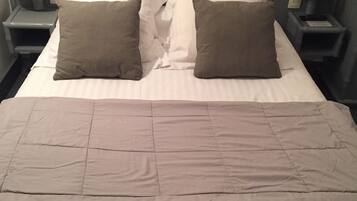 Comfortable bed with two nightstands and lamps.