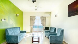 A living room with two sofas, a coffee table, and a TV. - Supun Arcade Residency (Colombo)