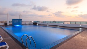 A rooftop swimming pool with a clear view of the city skyline at sunset. - Supun Arcade Residency (Colombo)