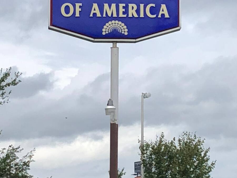 A blue octagonal sign with the text "Motor Inns of America" and a logo.