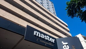 A hotel entrance with a sign reading "Master Cosmopolitan."