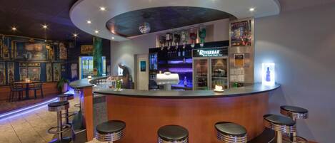 A bar area with a curved counter, multiple stools, and a River Bar sign.