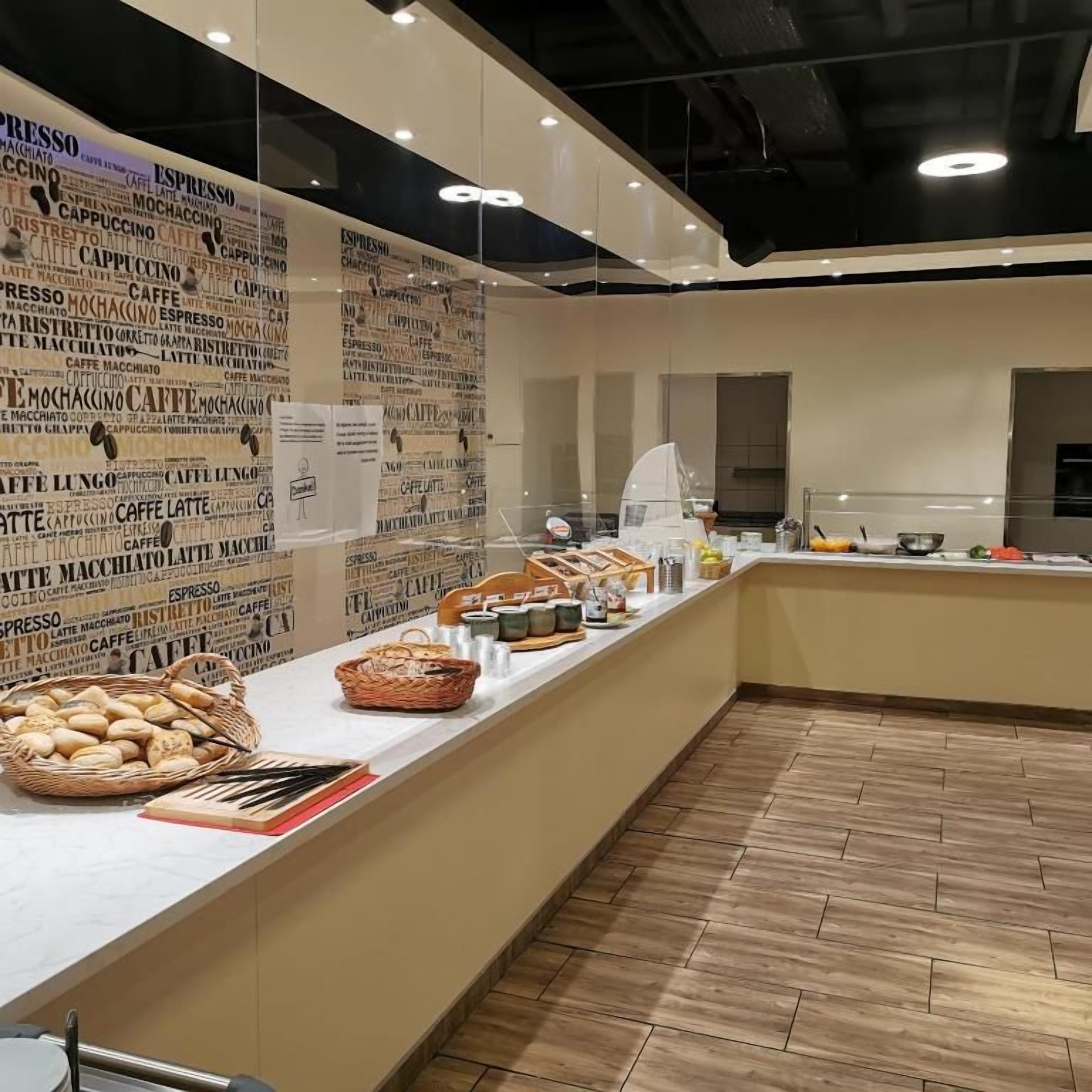 A café counter with a variety of coffee and pastry options, a menu board, and a clean, modern interior.
