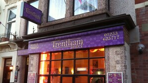The exterior of the Trentham Hotel with a purple signboard displaying the name and contact numbers. - Trentham Private Hotel (Blackpool)