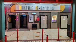 A cinema with two entrances, labeled 'Sala 1' and 'Sala 2,' and a sign for 'CINEMA AVENTURA.' - Park Place Hotel (Siguatepeque)