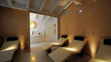 Relax in a serene spa room with three massage chairs, each with a footrest and control panel.