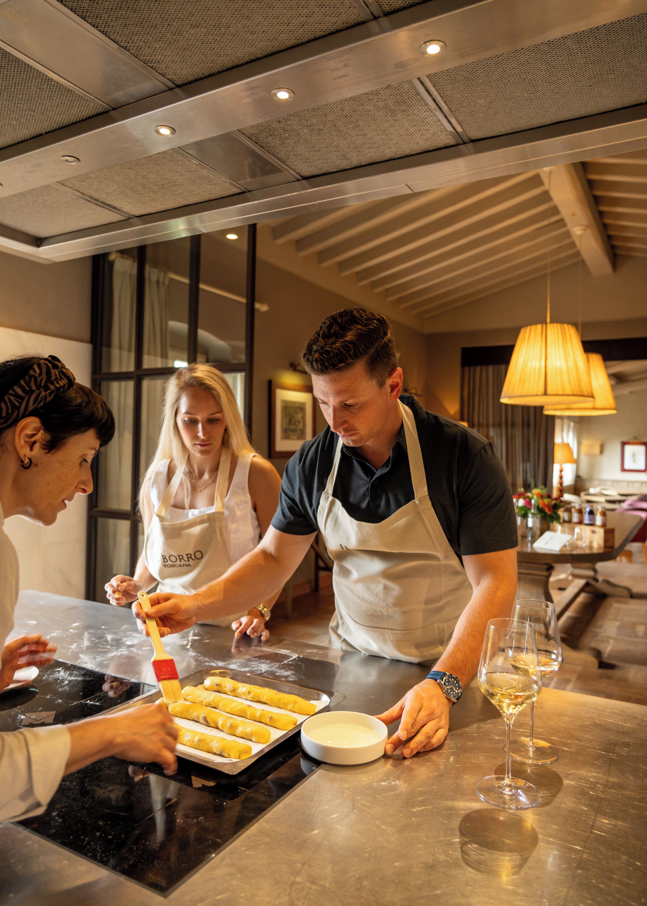 A group of people in a modern kitchen preparing food.