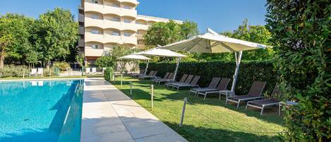 Seasonal outdoor pool, open 9 AM to 7:30 PM, pool umbrellas