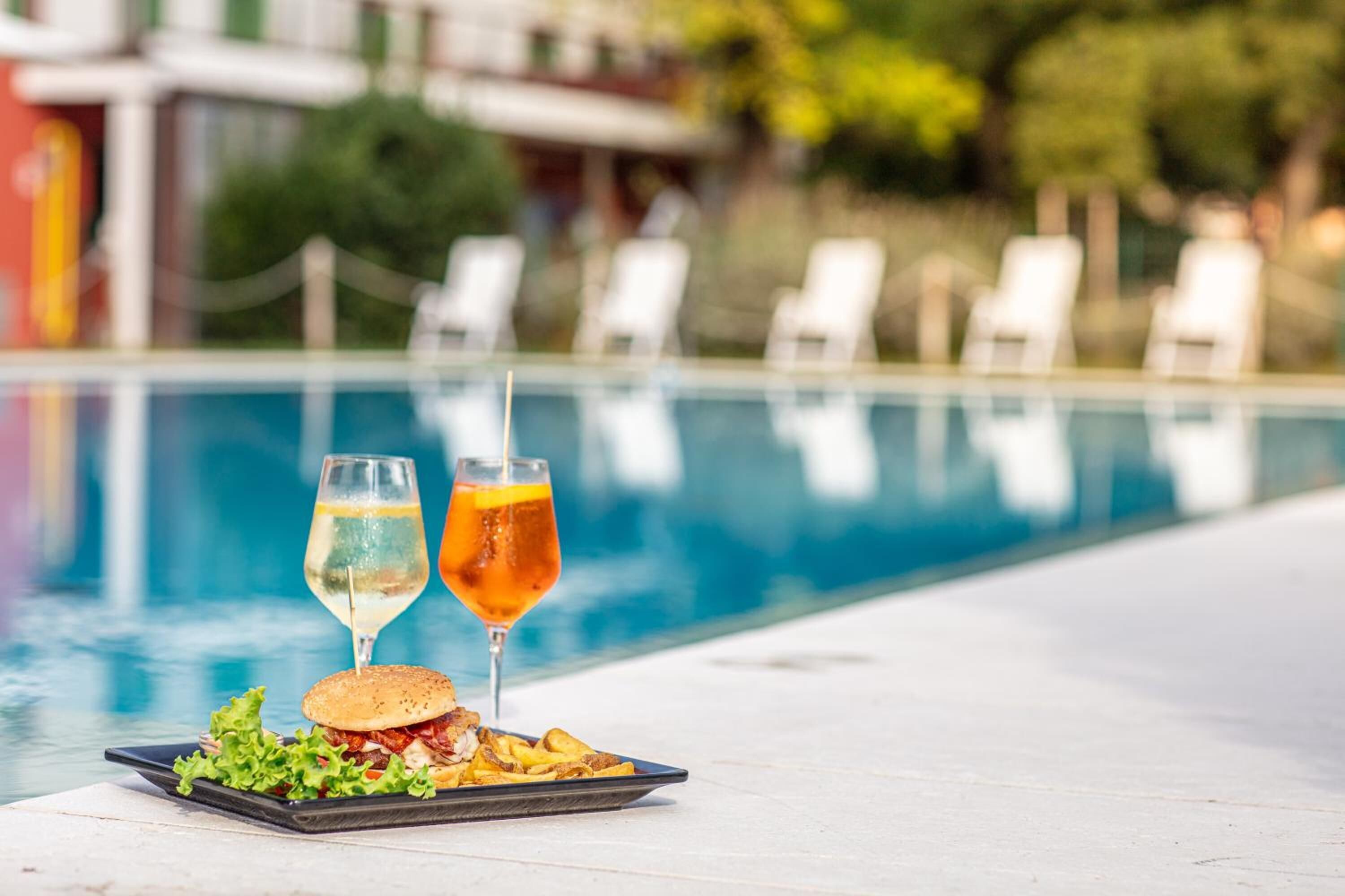 seasonal outdoor pool, open 9 am to 7:30 pm, pool umbrellas