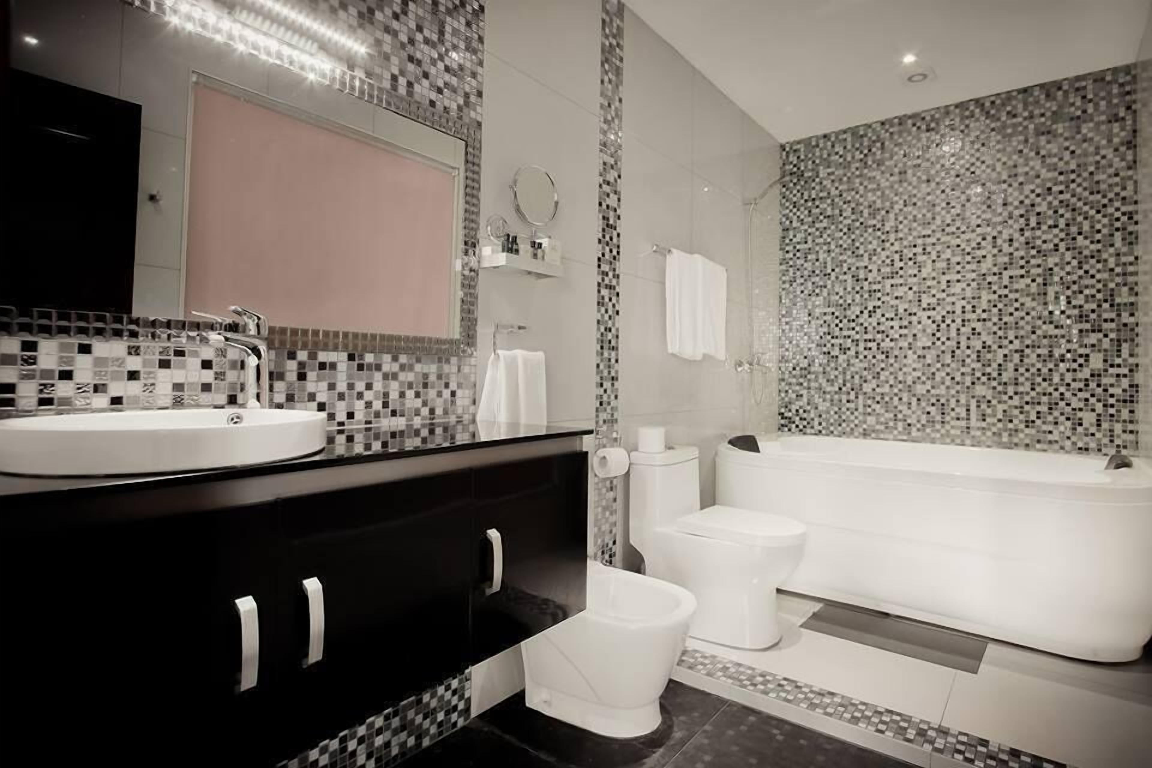 apartment, city view | bathroom | deep-soaking bathtub, hair dryer, bathrobes, slippers