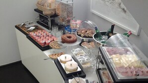 A buffet with various food items, including pastries, meats, and desserts. - Culture Hotel Centro Storico (Naples)