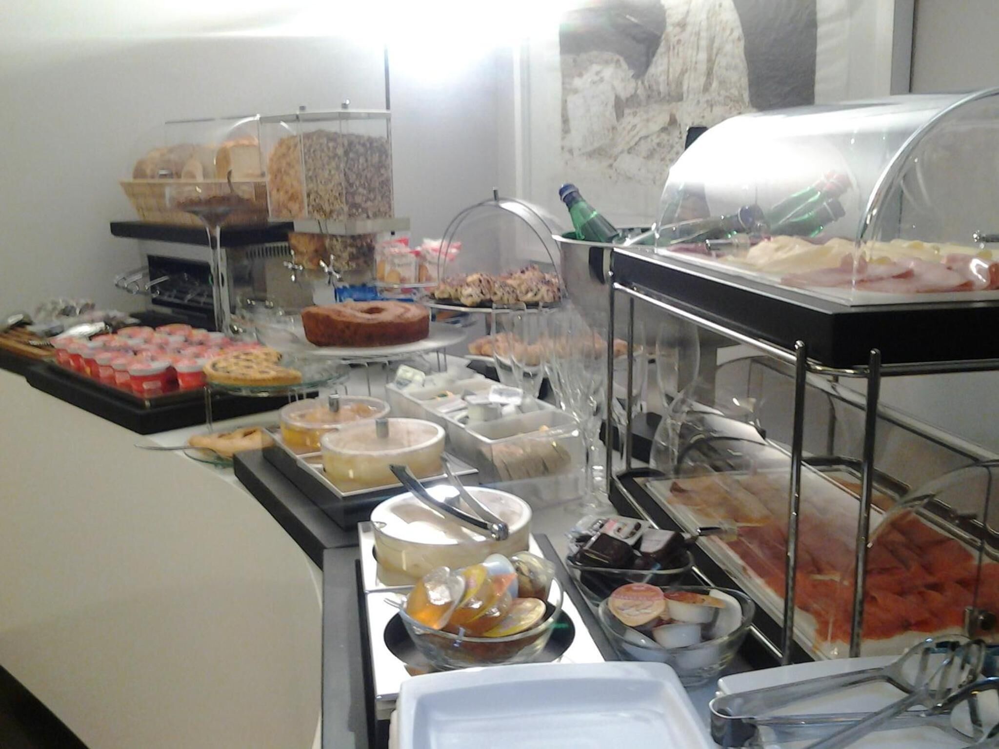 A buffet with various food items and a cake on display.