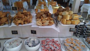 A buffet with various food items including pastries, bread, and dairy products. - Australis Paradise (Carilo)