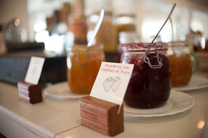 Jars of strawberry jam on display with labels.