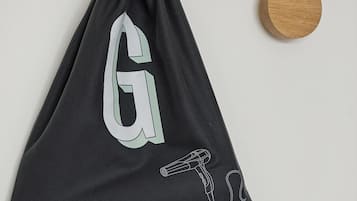 A black bag with a large 'G' and a hairdryer illustration.
