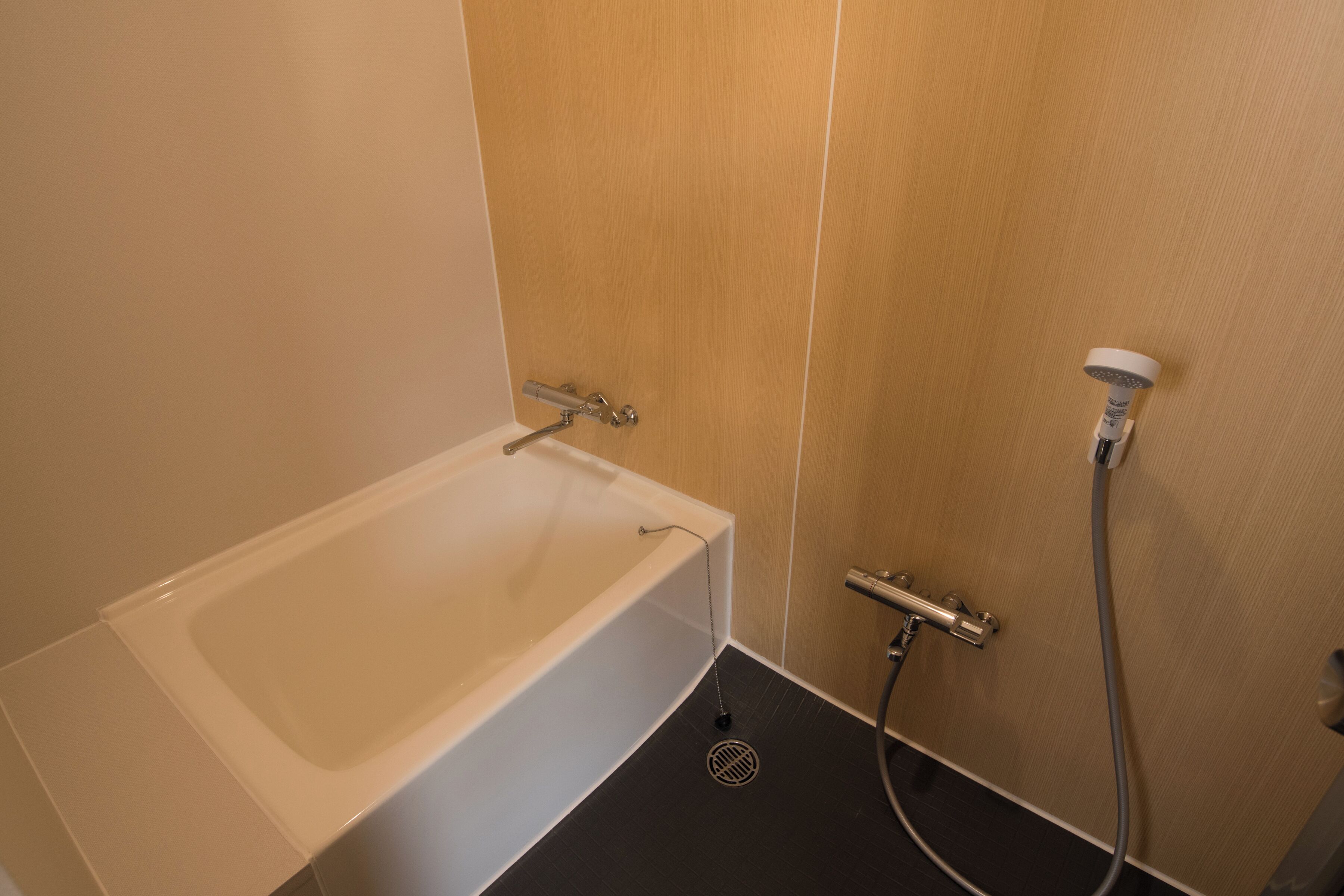A bathroom with a bathtub, a shower, and a toilet.