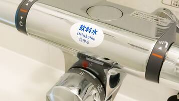 A water dispenser with a "Drinkable Water" label, a control knob, and a pressure gauge.