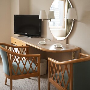 A hotel room with a desk, two chairs, a television, a mirror, and a window. - Takarazuka Washington Hotel (Takarazuka)