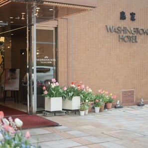 The exterior of the Washington Hotel with a tiled facade and a glass entrance. - Takarazuka Washington Hotel (Takarazuka)