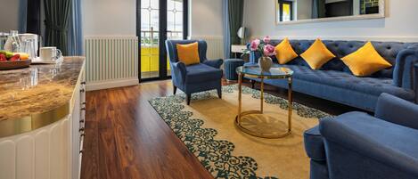 A modern living room with a blue sofa, yellow cushions, a coffee table, and a large mirror.
