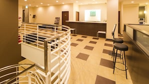 A hotel lobby with a reception desk, a staircase, and a bar area. - Urbain Hiroshima Central (Hiroshima)