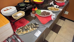 A buffet with various dishes, including fish, salads, and other prepared foods. - Urbain Hiroshima Central (Hiroshima)