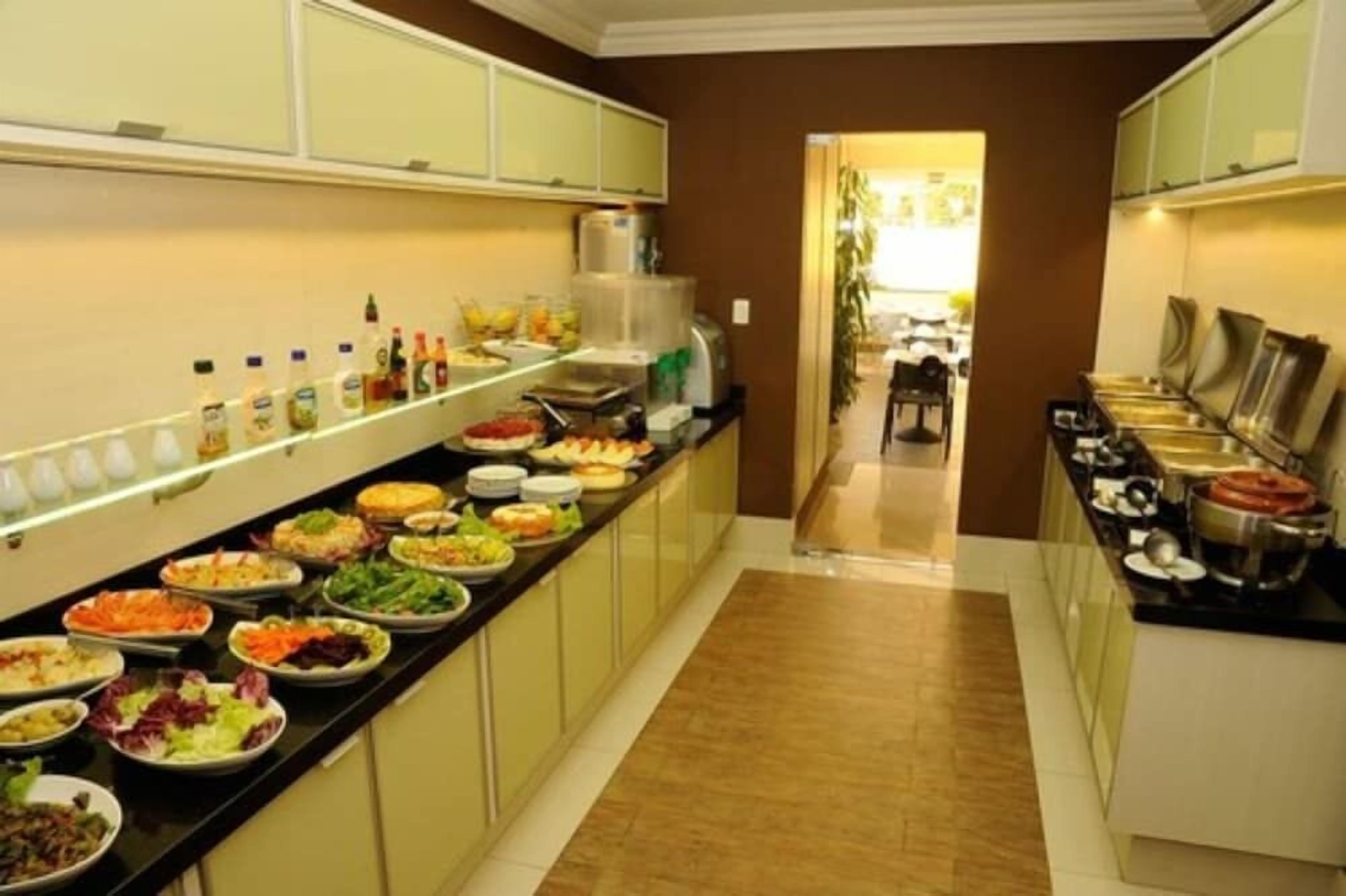 A buffet area with various food items and beverages.