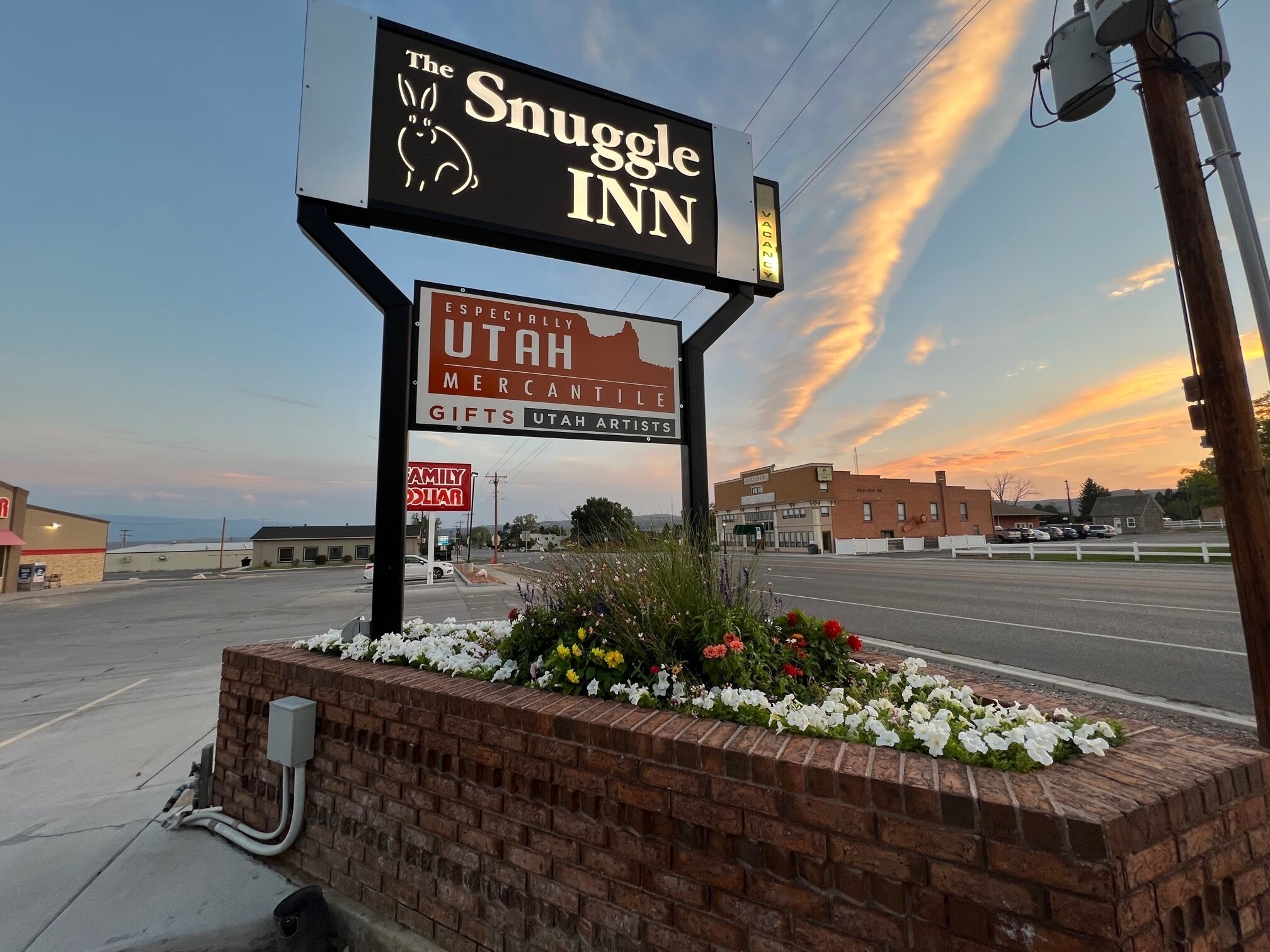 A hotel sign with a rabbit logo and the name "The Snuggle Inn".