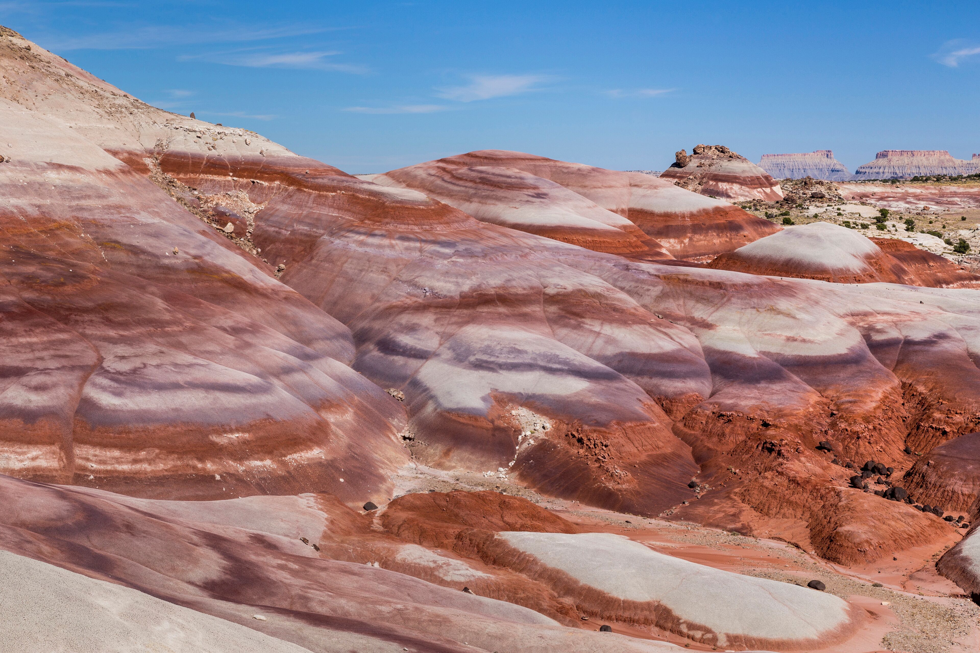 A landscape with undulating terrain and a clear sky.