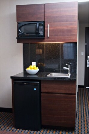 A compact kitchen with a microwave, sink, and a small refrigerator. - Holiday Inn Express Pembroke by IHG (Pembroke)