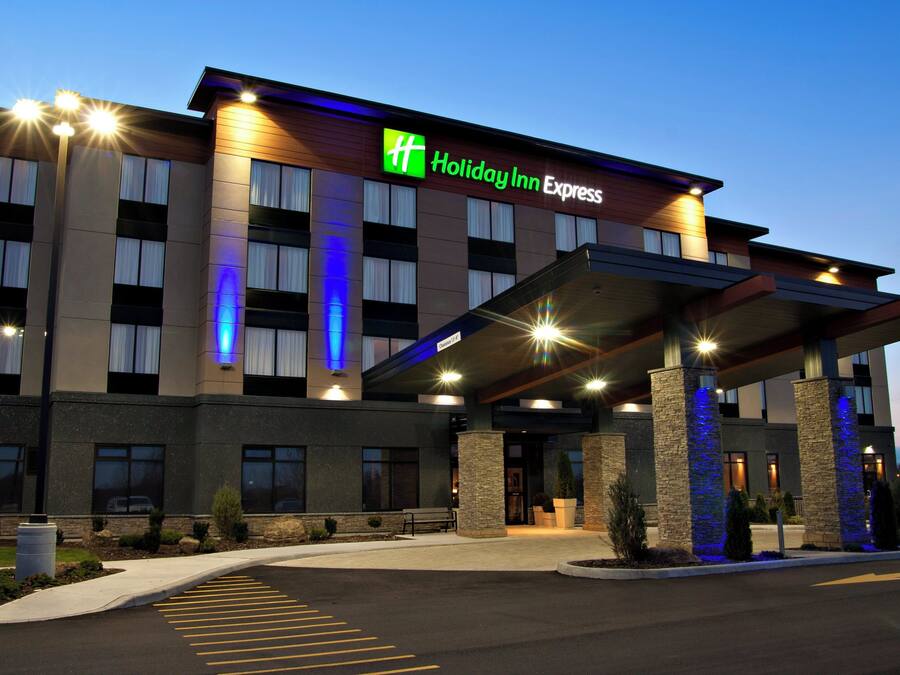 A Holiday Inn Express hotel with a modern facade, large windows, and a covered entrance area.